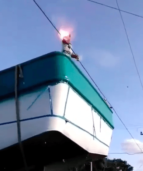 man touches electric wire