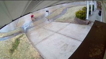 man slips down driveway