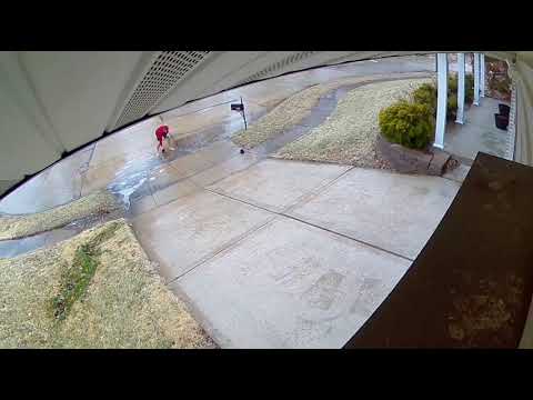 man slips down driveway