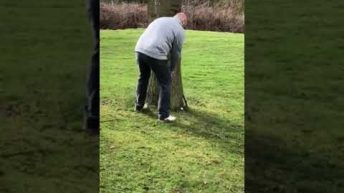 man hits golfball at crotch