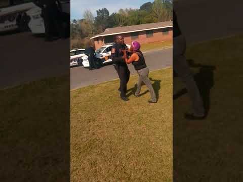 officer in the middle of fight