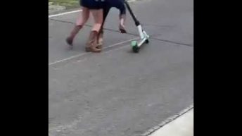 two girls have a scooter riding