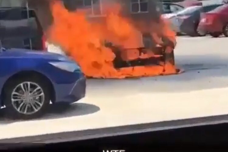 car burning in parking lot