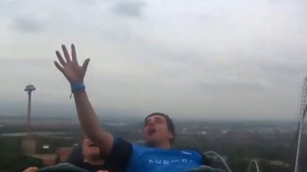 man catches cell phone on rollercoaster