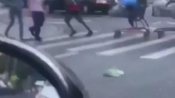 Man drags carts through the street
