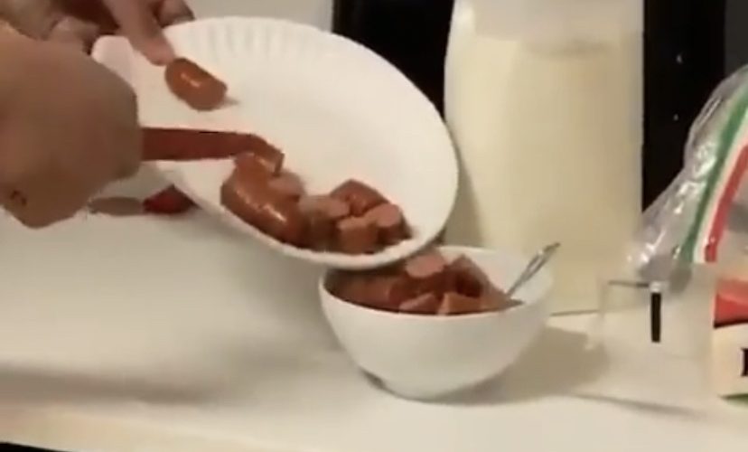 man eats hot dogs like cereal milk