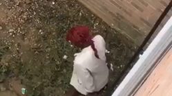 Woman poops on side of apartment complex