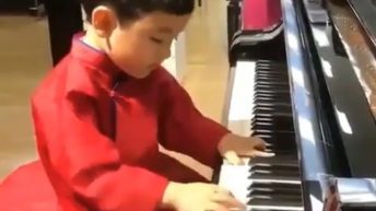 kid plays the piano