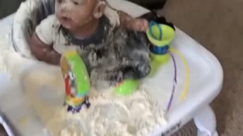 baby playing in flour