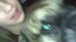 woman kisses dog in mouth