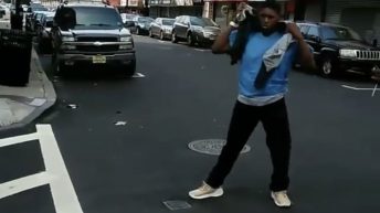 men fighting in the middle of the street