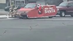 Santa drives down the street of Detroit