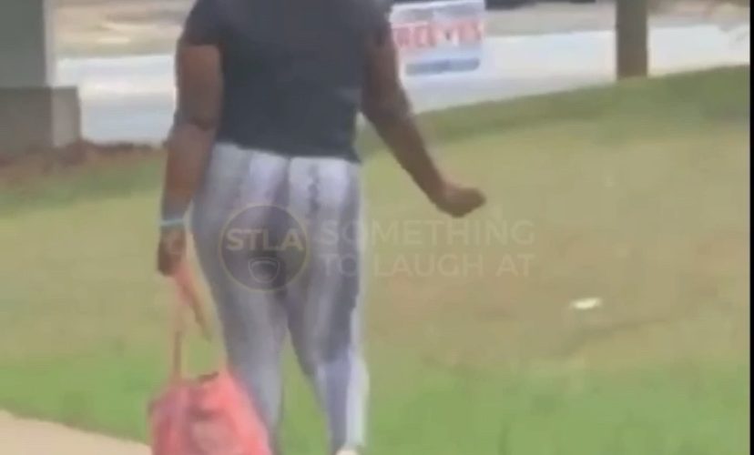 Woman struts her stuff on the sidewalk