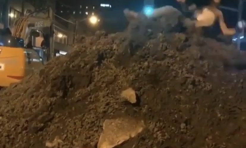 Woman falls off dirt pile