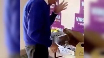 Mike Bloomberg licks finger while handling food