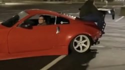 Man tries to hold onto car while performing drift