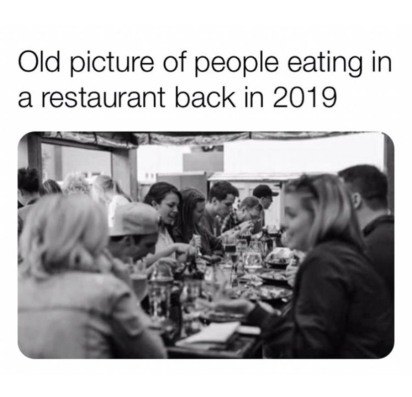 Old picture of people eating in a restaurant back in 2019 meme