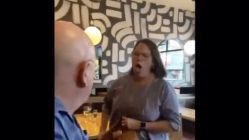 Angry woman coughs on man in restaurant