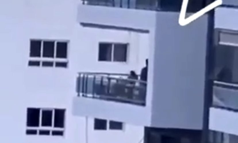 Man swings daughter over balcony