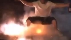 Man squats over exploding fireworks