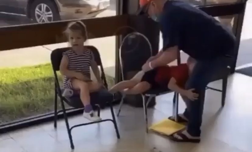 Man disciplines children in public