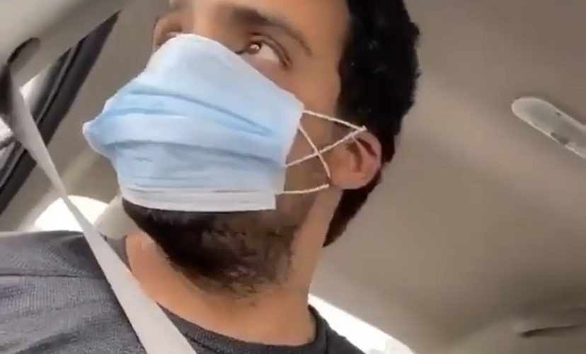 Man shows how to eat with coronavirus mask