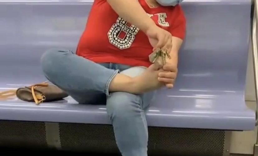 Woman grooms on subway