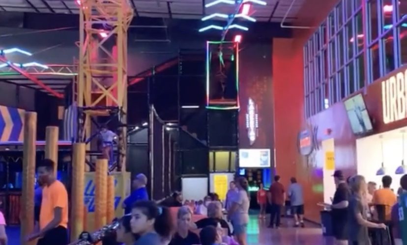 Man flies down indoor zipline
