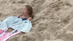 Girl catches seagull on beach