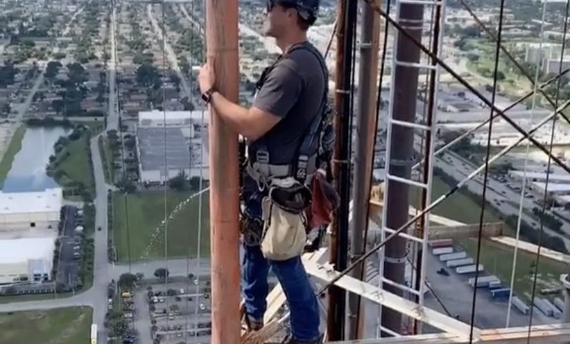 A tower climber shows how they go while working