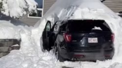 Car trapped under pile of snow
