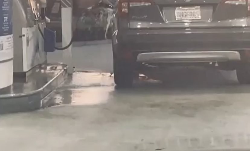 woman slips and falls pumping gas