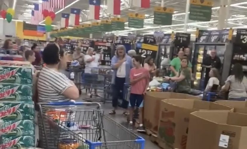 Walmart customers sing the National Anthem