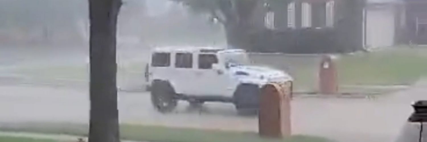 Woman gets caught in rain with Jeep top down