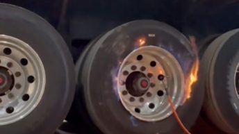 Truck driver fixes flat tire with fire