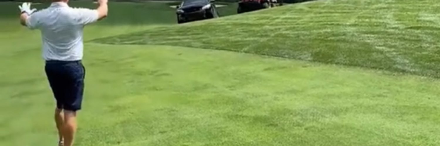Man drives car on golf course
