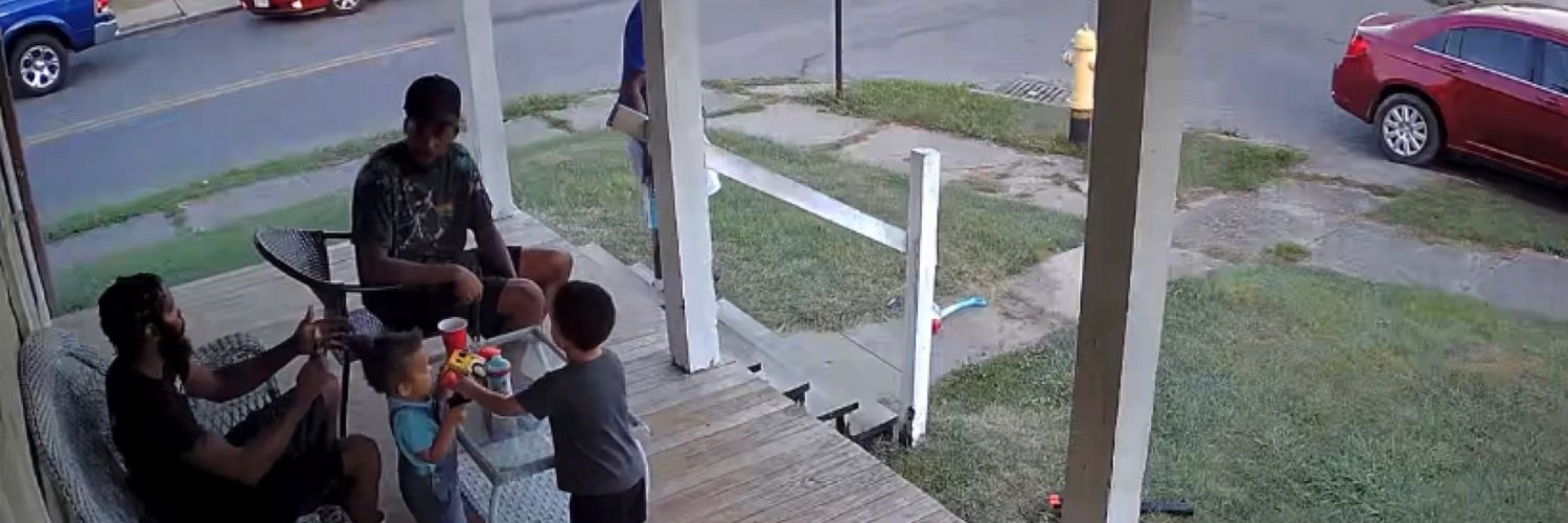 Men take off running from a loose dog while sitting on a porch.