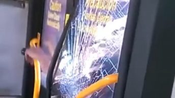 Angry man breaks through bus window