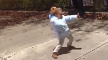 Little girl dances to drill team music