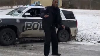 Officers slip and fall on an iced street
