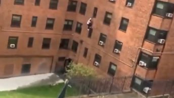 A man escapes an apartment building by jumping out of a 3rd-floor window. 