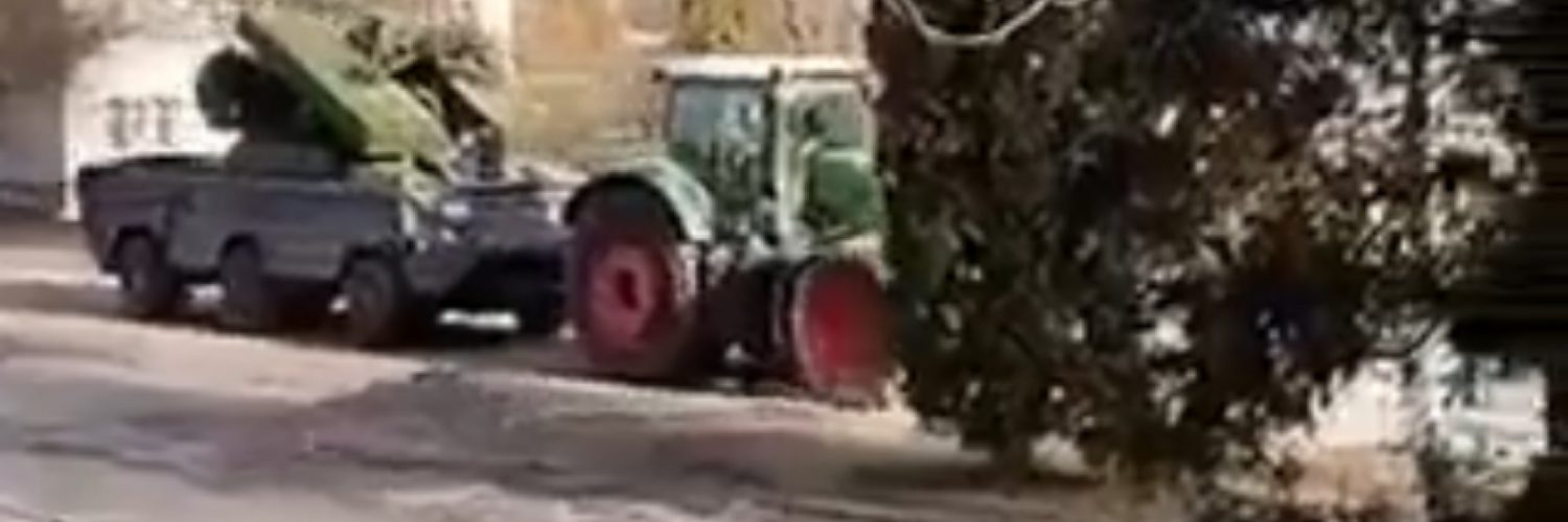 Ukrainian farmer tows a Russian tank