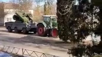 Ukrainian farmer tows a Russian tank