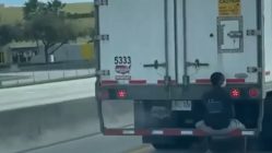 Man caught hitching a ride on the back of an 18 wheeler