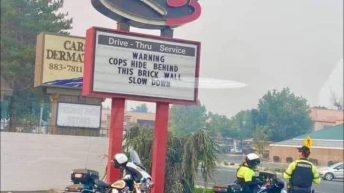 Warning cops hide behind this brick wall slow down Arby’s Sign
