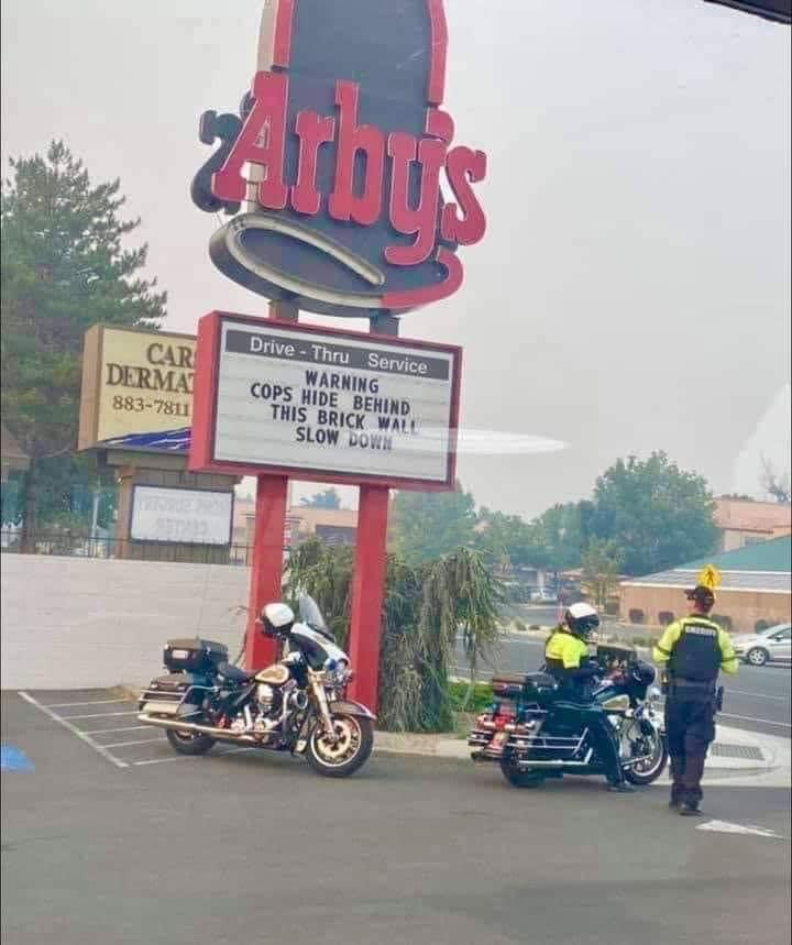 Warning cops hide behind this brick wall slow down Arby’s Sign 