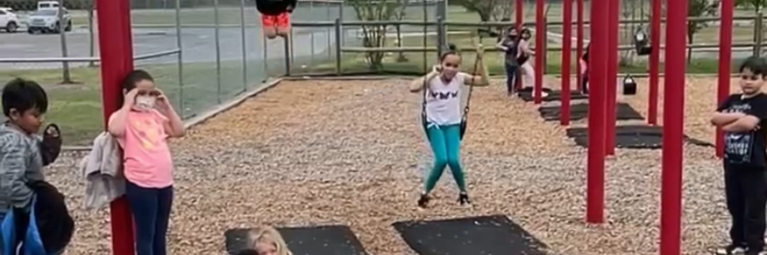 Daredevil kid jumps off swing over kids