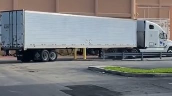 A truck driver wrecks a truck after accidentally backing into a concrete pylon.