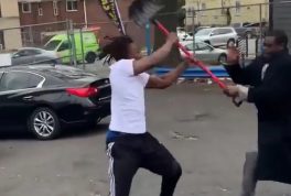 Men fight at a car lot